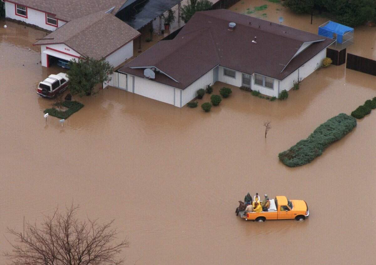 A truck drives through a neighborhood in Willows in February 1998 after days of rain flooded the area.